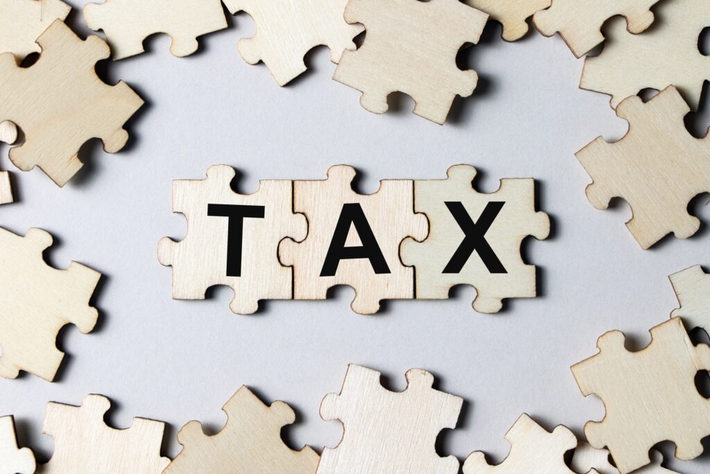 Puzzle pieces with word tax